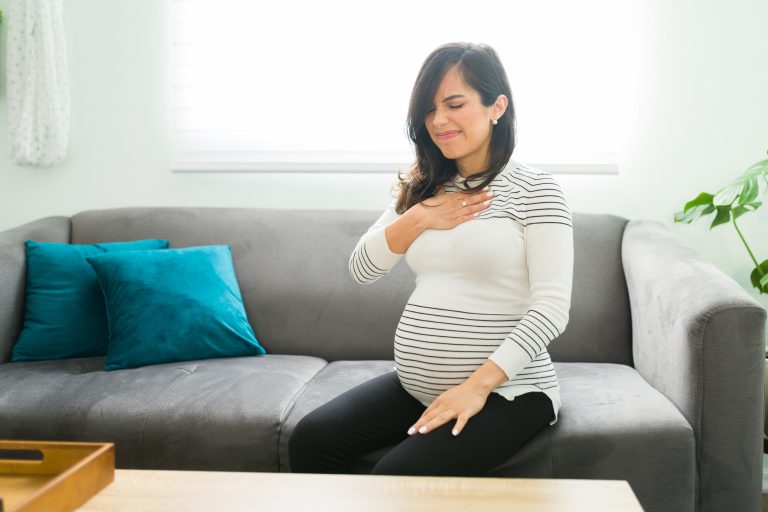 Pretty pregnant woman suffering from acid reflux