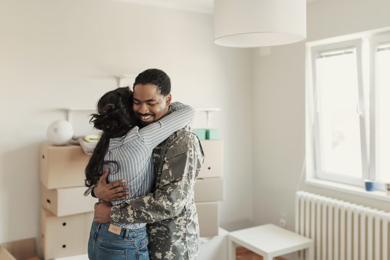 A soldier in uniform loves his wife in new house