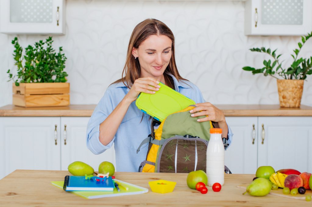 A mom packs a school lunch for her child