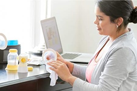 A woman cleans her breast pump at her desk