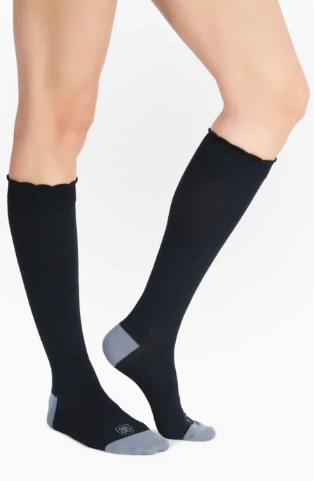 Model wearing compression socks profile view