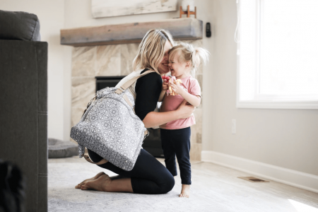 A mom and her daughter use the Lizzy breast pump bag