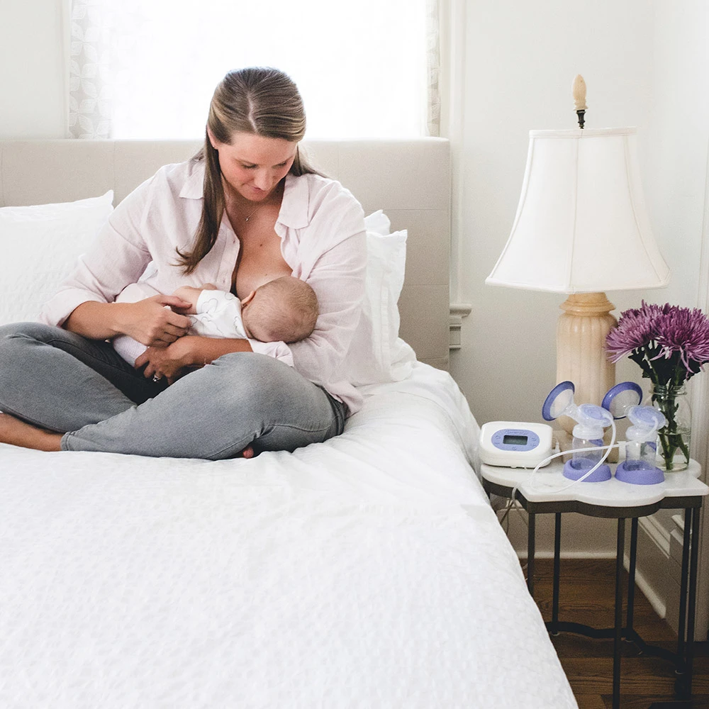 A woman breastfeeds her baby