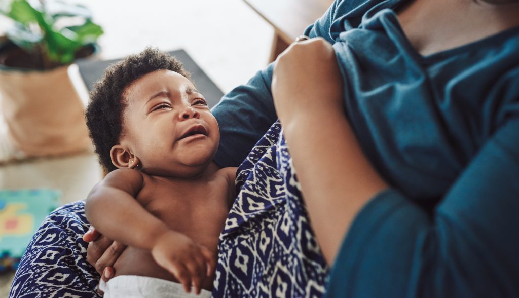 Cropped shot of a girl being breastfed by her mother