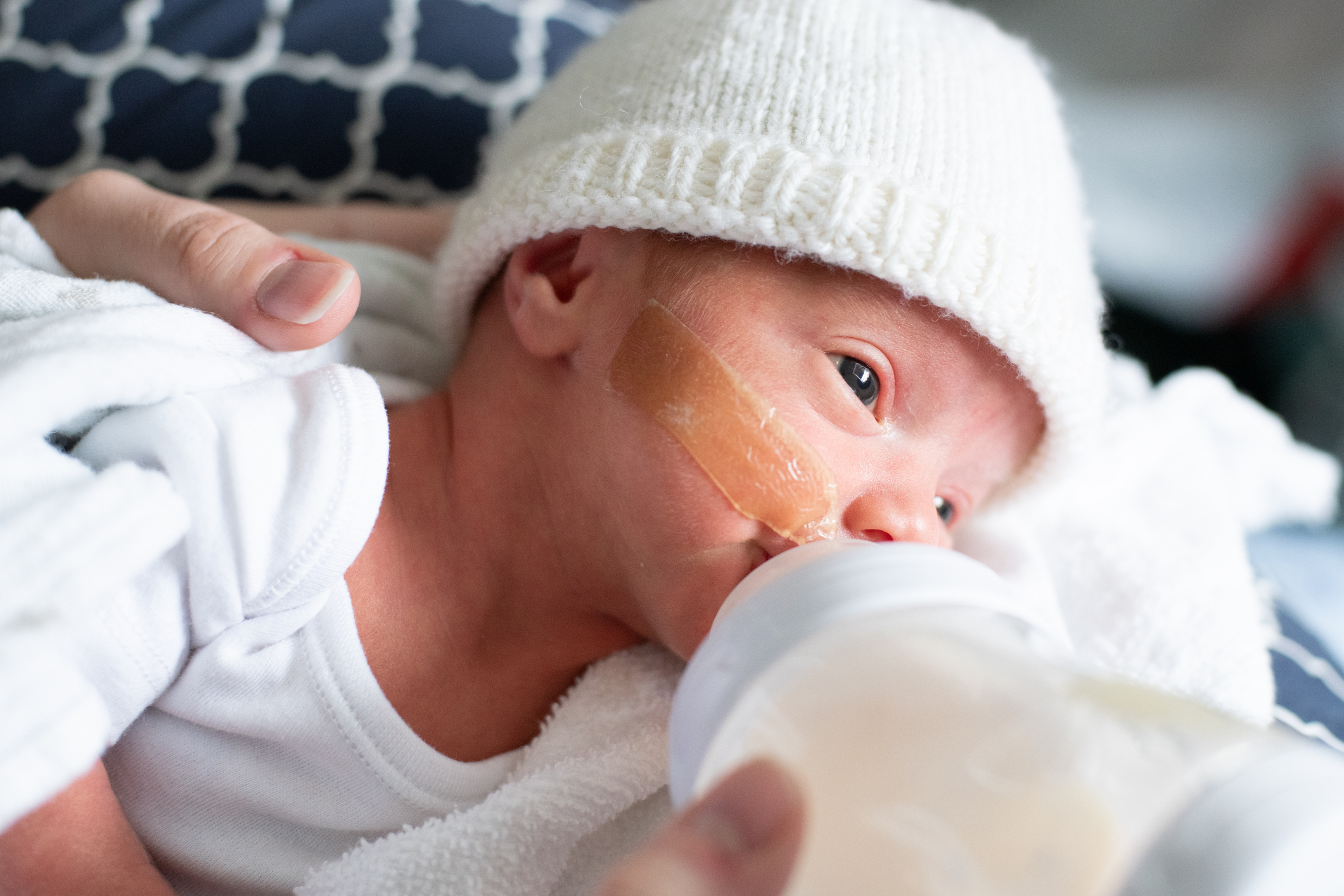 A premature baby drinks a bottle