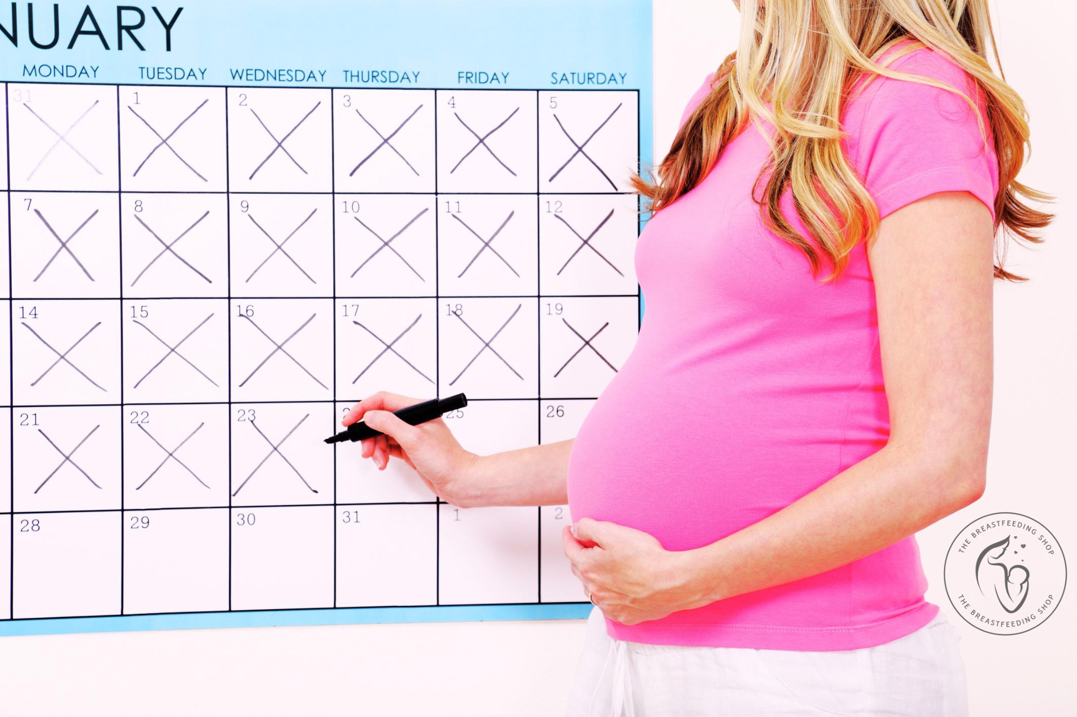 Pregnant mother tracking her due date on her calendar