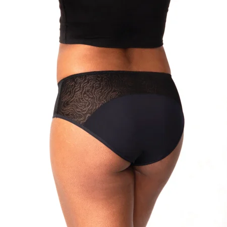 A mom wearing Saalt Leak proof underwear black lace, displaying a backside view