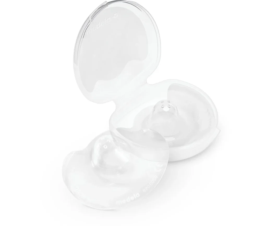 Two clear Medela Contact nipple shields beside their open storage case