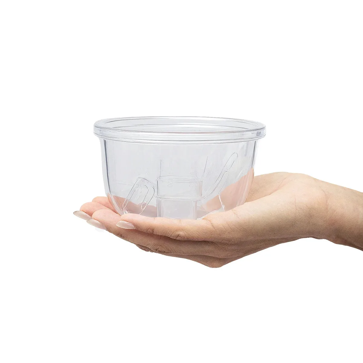 Clear Zomee hands-free collection cup resting in a hand, showing its size
